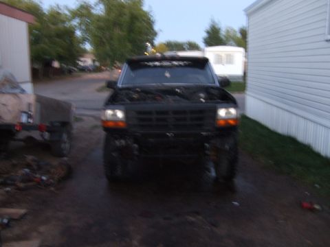 1989 Ford Bronco - Front view of a 1992 Ford Bronco with its hood open, parked outdoors.