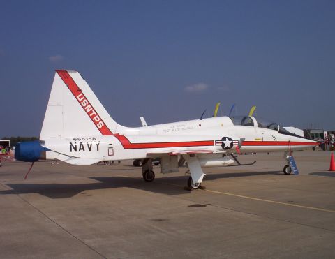 2003 Ford Crown Victoria - A US Navy T-45 Goshawk jet trainer is parked on an airfield tarmac under a clear blue sky.