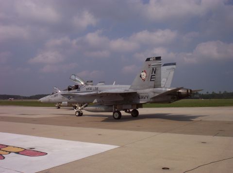2003 Ford Crown Victoria - A U.S. Navy F/A-18F Super Hornet sits on the tarmac with its canopy open, alongside another aircraft.