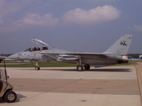 2003 Ford Crown Victoria - A U.S. Navy F-14 Tomcat fighter jet is parked on the tarmac with its canopy open.