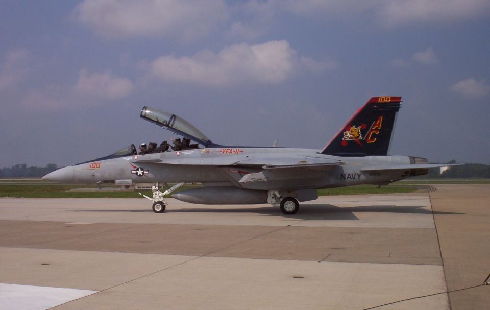 F/A-18 Hornet fighter jet with open canopy on tarmac