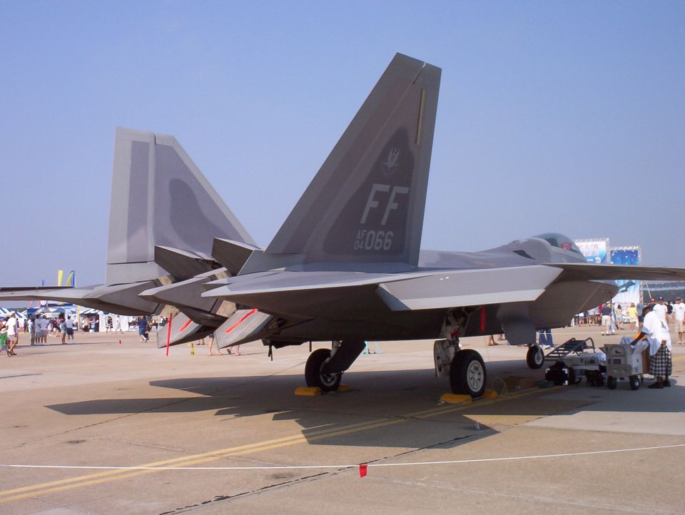 Rear view of two F-22 Raptor fighter jets on tarmac, with 'FF 066' visible on one