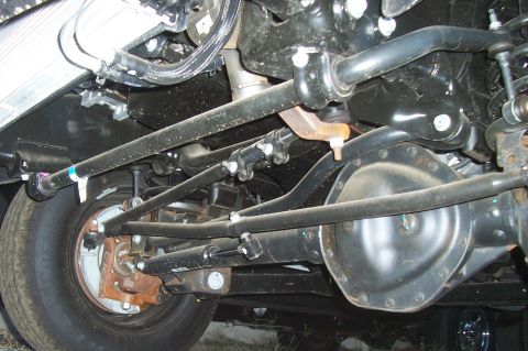 1994 Ford F-150 - Close-up of the front axle and steering system, showing various mechanical parts.
