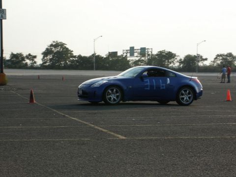 2001 Mercury Grand Marquis - A blue coupe with the number 316 on its side navigates a course marked by orange cones.