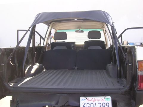 1985 Toyota 4Runner - Rear view of a 1985 Toyota 4Runner, showing the bed, seats, and soft top.