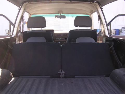 1985 Toyota 4Runner - The interior of a 1985 Toyota 4Runner, viewed from the cargo area towards the front seats.