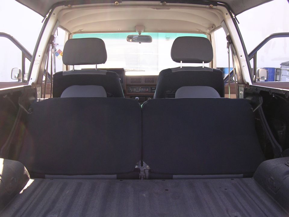 SUV interior from the tailgate with rear seats folded flat and front buckets beyond