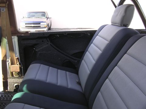 1985 Toyota 4Runner - Interior view showing seats and a blue pickup truck parked outside.