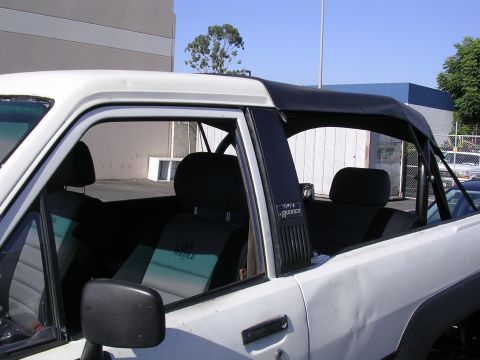 1985 Toyota 4Runner - Close-up view of the interior of a 1985 Toyota 4Runner, highlighting the seat covers and soft top.