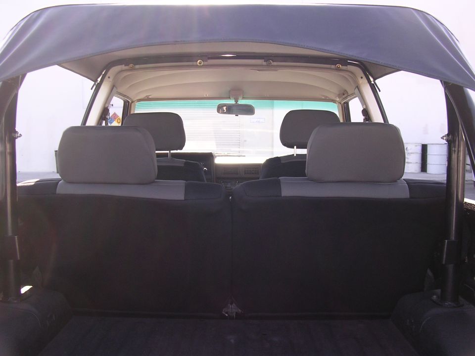 1985 Toyota 4Runner interior, rear seats and soft top visible. Gray upholstery shows some wear