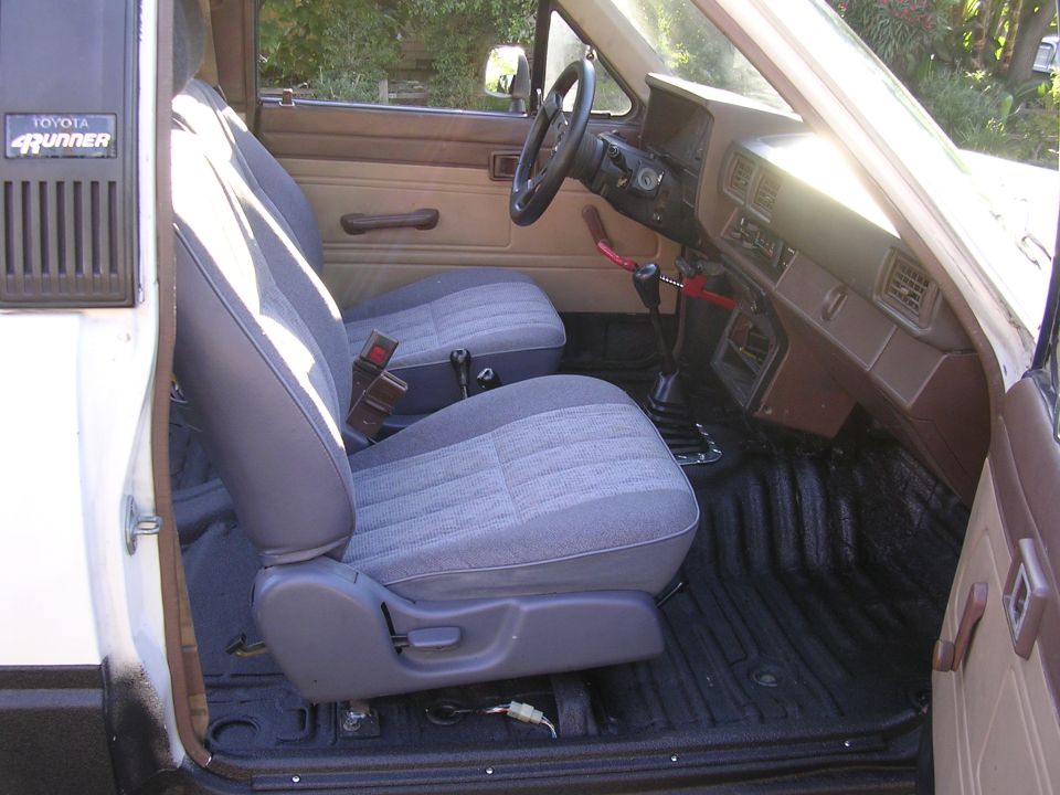 Toyota 4Runner interior with gray cloth seats and black bedliner floor, brown dash