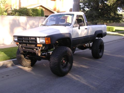 1985 Toyota 4Runner - This modified 1985 Toyota pickup truck features a lifted suspension and oversized off-road tires, giving it a stance.
