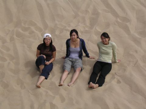 1985 Toyota 4Runner - Three women relax on a sandy incline, enjoying a sunny day outdoors.