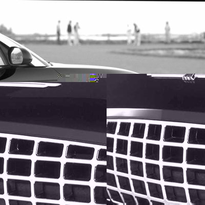 2002 Ford Thunderbird - Close-up view of the front grille and fender of a dark-colored vehicle, with a side mirror visible.