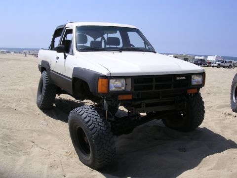 1985 Toyota 4Runner - Modified 1985 Toyota 4Runner parked on the sand with the ocean in the background.