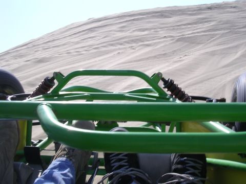 1985 Toyota 4Runner - The view from inside a dune buggy as it travels over sandy terrain under a clear sky.