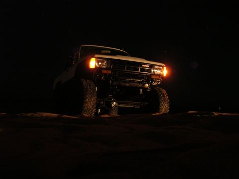 1985 Toyota 4Runner - Modified 1985 Toyota 4Runner with large tires and winch, photographed at night.