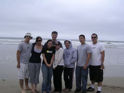 1985 Toyota 4Runner - A group of friends enjoys a day at the beach, with waves crashing in the distance.