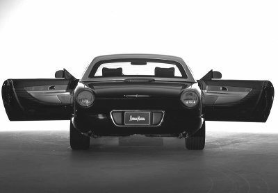 2002 Ford Thunderbird - A black 2002 Ford Thunderbird convertible is shown from the rear with both doors open, displaying its Neiman Marcus badging.