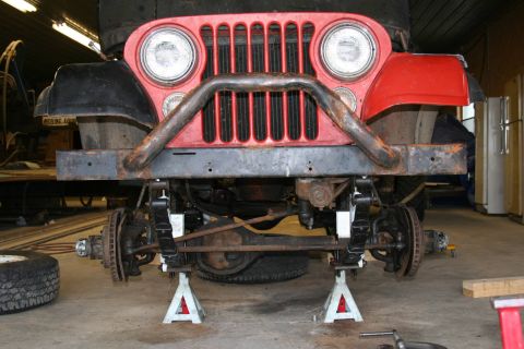 1979 Jeep CJ5 - Front view of a 1979 Jeep CJ5 undergoing repairs, showing suspension and brake components.