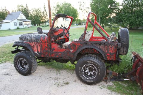 1979 Jeep CJ5 - This 1979 Jeep CJ5 is heavily covered in mud, suggesting recent off-road use.