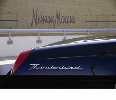 2002 Ford Thunderbird - Side view of a dark blue Thunderbird convertible, with the Neiman Marcus logo visible in the background.