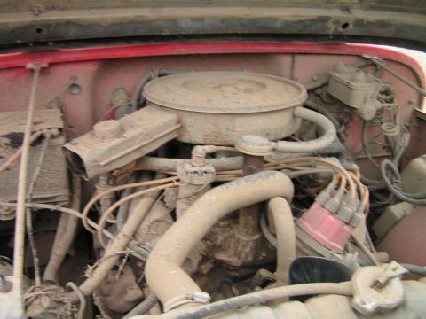 1979 Jeep CJ5 - Close-up view of a dusty engine bay, showing the air cleaner and distributor cap.