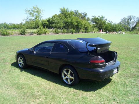 1998 Dodge Avenger - 1998 Dodge Avenger coupe with an open trunk and a prominent aftermarket spoiler, seen from the rear.