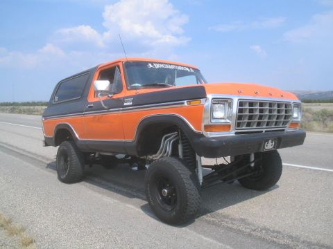 1979 Ford Bronco - This modified 1978 Ford Bronco features a prominent grille and lifted suspension, seen on a roadside.