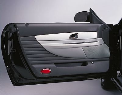 2002 Ford Thunderbird - Interior view of a car door panel with a silver accent strip and textured gray inserts.