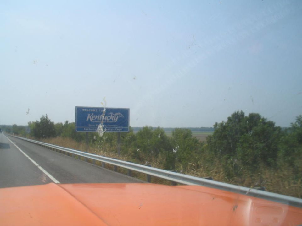 Welcome to Kentucky sign seen from a vehicle on the highway