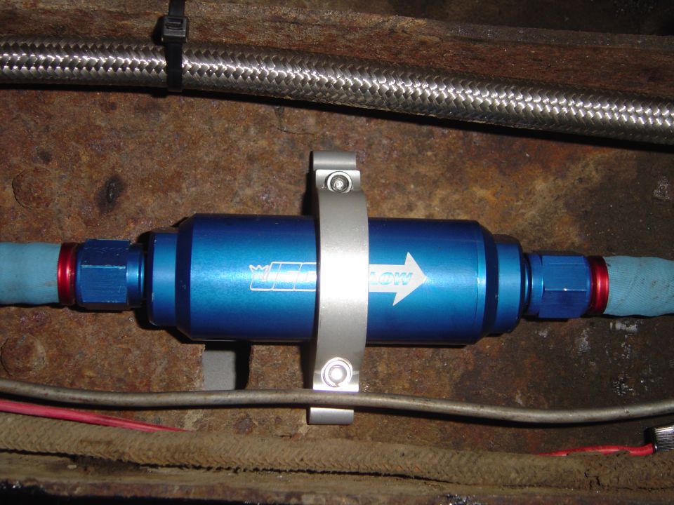 Blue fuel filter with white arrow and 'FLOW' text