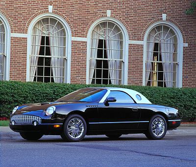 2002 Ford Thunderbird - Black 2002 Ford Thunderbird convertible with a white hardtop sits in front of a brick building.