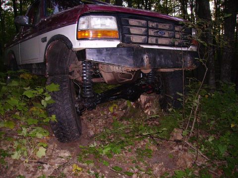 2000 Chevrolet Tahoe - This lifted Ford F-Series truck, likely from the early 1990s, is shown from the front in a forest setting.