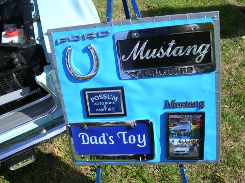 1996 Ford Probe - A display board Ford Mustang memorabilia, including license plates and a horseshoe, is set up outdoors.