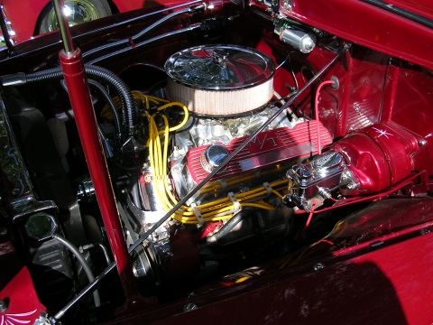 1996 Ford Probe - Close-up view of a custom engine bay with polished components and vibrant yellow spark plug wires.