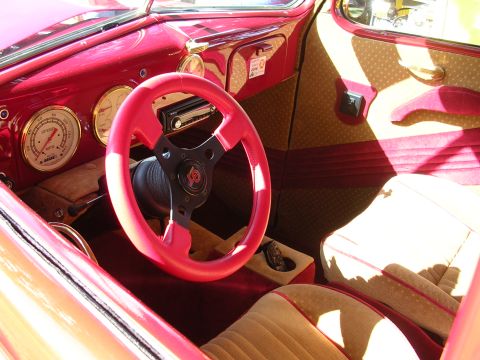 1996 Ford Probe - The custom interior features a bright red steering wheel, tan upholstered seats, and classic gauges, suggesting a vehicle from an earlier e…