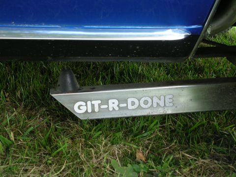 1996 Ford Probe - A blue car's side step displays the custom text "GIT-R-DONE" against a grassy background.