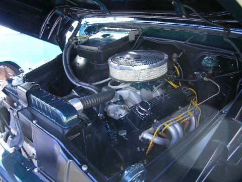 1996 Ford Probe - Close-up view of a V8 engine bay, an aftermarket air cleaner and exhaust headers.