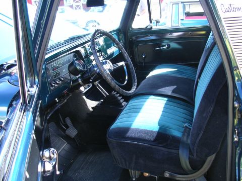 1996 Ford Probe - The interior of this vintage truck features striped teal and black seats and a classic dashboard.