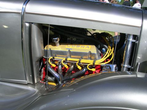 1996 Ford Probe - Engine bay detail showing a V8 engine with prominent yellow Cobra valve covers and chrome exhaust headers.