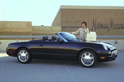 2002 Ford Thunderbird - A woman stands by a black 2002 Ford Thunderbird convertible outside a Neiman Marcus store.