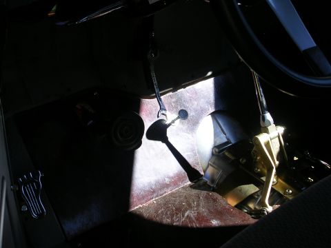 1996 Ford Probe - A sunbeam illuminates the floor pedals and gear shifter inside a vehicle.