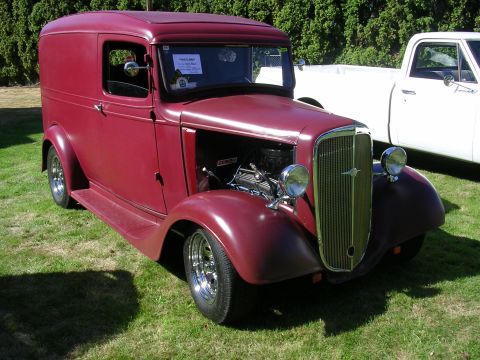 1996 Ford Probe - Customized panel truck from the 1930s displayed at a car show.