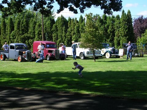1996 Ford Probe - A collection of classic vehicles is displayed on a sunny day at an outdoor car show.