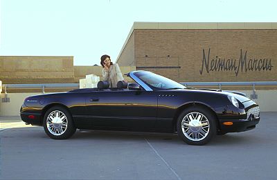2002 Ford Thunderbird - A black 2002 Ford Thunderbird convertible is shown parked in front of a Neiman Marcus store.