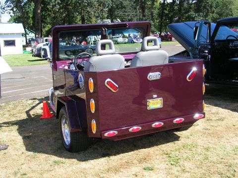 1996 Ford Probe - This custom vehicle, seen from the rear, features a unique open-top design and a truck bed, with an Oregon license plate visible.