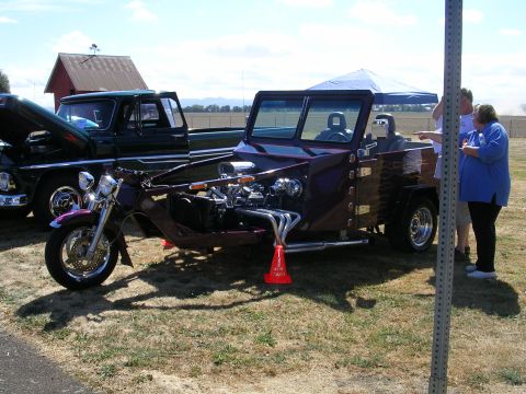 1996 Ford Probe - Custom trike and pickup truck at an outdoor car show.