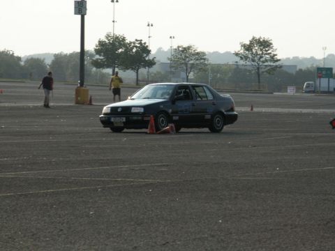2001 Mercury Grand Marquis - A dark sedan is parked on an asphalt lot with orange cones around it.