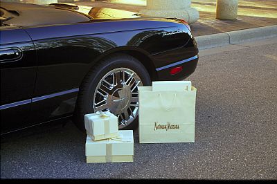 2002 Ford Thunderbird - Neiman Marcus shopping bag and gift boxes next to a 2002 Ford Thunderbird.